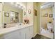 Bright bathroom featuring a white vanity and a large mirror with vanity lights above it at 1675 Paddlewheel Dr, Marietta, GA 30062