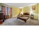 Bedroom with neutral carpet, yellow walls, and abundant natural light coming through curtained windows at 1675 Paddlewheel Dr, Marietta, GA 30062