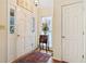 Inviting entryway showcasing a decorative rug, a stylish table with a floral arrangement, and ample natural light at 1675 Paddlewheel Dr, Marietta, GA 30062