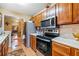 Kitchen showcasing wooden cabinets, stainless steel appliances, and seamless transition into dining area at 1675 Paddlewheel Dr, Marietta, GA 30062