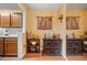 Kitchen area with natural wooden cabinets adjacent to a dining area with decorated buffets at 1675 Paddlewheel Dr, Marietta, GA 30062