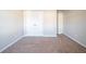 Bedroom featuring neutral colored walls, carpet flooring, and a closet with double doors at 2397 Shady Maple Trl, Loganville, GA 30052