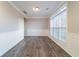 This dining room has hardwood floors, with a light and a large window at 2397 Shady Maple Trl, Loganville, GA 30052