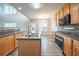 Stylish kitchen with wood cabinets, stainless steel appliances, and view to living area at 2397 Shady Maple Trl, Loganville, GA 30052