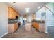 Modern kitchen with stainless steel appliances, wood cabinets, and a functional island at 2397 Shady Maple Trl, Loganville, GA 30052