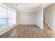 Living room features hardwood floors, with stairs that lead to the second story at 2397 Shady Maple Trl, Loganville, GA 30052