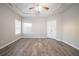 Main bedroom with a tray ceiling, a ceiling fan, and walk-in closet at 2397 Shady Maple Trl, Loganville, GA 30052