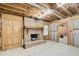 Unfinished basement featuring exposed ceiling, brick fireplace, and unfinished cinderblock walls at 2658 Stonehenge Ct, Dunwoody, GA 30360