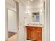 Bright bathroom featuring a vanity with a brown cabinet, granite countertop and neutral colored walls at 2658 Stonehenge Ct, Dunwoody, GA 30360