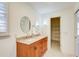 Bright bathroom featuring a double sink vanity with granite countertop and access to a closet at 2658 Stonehenge Ct, Dunwoody, GA 30360