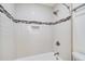 Shower stall features white subway tile with decorative accent stripe and built in niche at 2658 Stonehenge Ct, Dunwoody, GA 30360