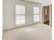 Bright bedroom features neutral carpet, white walls, and windows with blinds at 2658 Stonehenge Ct, Dunwoody, GA 30360