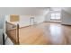 Large bonus room with light colored wood flooring, white walls and a window at 2658 Stonehenge Ct, Dunwoody, GA 30360