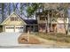 Charming two-story home features attached two-car garage, beautiful front yard with mature trees and well-maintained landscaping at 2658 Stonehenge Ct, Dunwoody, GA 30360