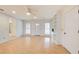 Sunlit living room with white walls and ceilings with hardwood floor, built-in shelves and a front door at 2658 Stonehenge Ct, Dunwoody, GA 30360