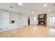 Bright living room features built-in bookshelves, a brick fireplace, and light-colored wood floors at 2658 Stonehenge Ct, Dunwoody, GA 30360