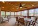 Screened-in back porch featuring a dining table and seating area with a wood paneled ceiling at 2658 Stonehenge Ct, Dunwoody, GA 30360