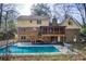 Beautiful backyard featuring a refreshing swimming pool and a charming two-story home with brick and siding at 2658 Stonehenge Ct, Dunwoody, GA 30360