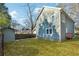 Spacious backyard with green grass, shed, and small deck on a sunny day at 438 Ansley St, Decatur, GA 30030