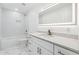 Modern bathroom featuring white subway tile, marble floors, and a vanity with quartz countertop at 438 Ansley St, Decatur, GA 30030