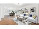 Bright and airy living room featuring a modern sofa, stylish rug, and hardwood floors at 438 Ansley St, Decatur, GA 30030