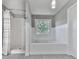 Bathroom featuring a separate shower and tub with wainscoting and tile floors at 1633 Moonlake Nw Trl, Kennesaw, GA 30152