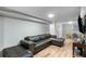 This living room is equipped with a dark leather sofa, hardwood floors and a wall mounted television at 1783 Mckenzie Dr, Decatur, GA 30032