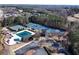Aerial view of community amenities including pool, tennis courts, and a playground surrounded by lush greenery at 2560 Millwater Xing, Dacula, GA 30019