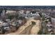 An aerial view showing the golf course, clubhouse, and surrounding neighborhood in a well-maintained community at 2560 Millwater Xing, Dacula, GA 30019