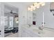 Bathroom featuring double sink vanity, bright lighting, and access to a balcony at 2560 Millwater Xing, Dacula, GA 30019