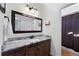 A bathroom features a large vanity with white countertop, a dark wood cabinet, and a shower at 2560 Millwater Xing, Dacula, GA 30019