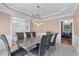 A formal dining room boasts wainscoting, a stylish marble-top table and modern lighting at 2560 Millwater Xing, Dacula, GA 30019