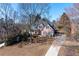 Exterior shot of a brick home with a sprawling front yard and mature trees, on a sunny day at 2560 Millwater Xing, Dacula, GA 30019
