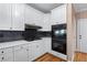 Modern kitchen features white cabinetry, stone backsplash, and stainless steel appliances at 2560 Millwater Xing, Dacula, GA 30019