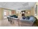 Spacious living room with a cozy fireplace, plush seating, and french doors to another room at 2560 Millwater Xing, Dacula, GA 30019