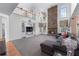 A large living room includes built-in shelving and a floor-to-ceiling stone fireplace at 2560 Millwater Xing, Dacula, GA 30019