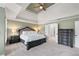 Main bedroom with large bed, decorative ceiling, and natural light at 2560 Millwater Xing, Dacula, GA 30019