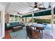 Inviting screened porch with comfortable seating, ceiling fans, and views of the backyard and pool at 2560 Millwater Xing, Dacula, GA 30019