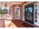 Inviting front porch featuring brick accents, white columns, and a stylish front door at 2560 Millwater Xing, Dacula, GA 30019