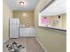 A convenient wet bar area includes a fridge, microwave, sink and white cabinets at 2560 Millwater Xing, Dacula, GA 30019