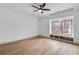 Bedroom featuring hardwood floors, a ceiling fan, and a window seat with built-in storage at 3927 Enclave Way, Tucker, GA 30084