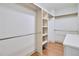 Walk-in closet featuring wood floors and built-in shelving at 3927 Enclave Way, Tucker, GA 30084