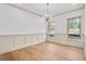 Bright dining room with decorative lighting fixture and hardwood floors at 3927 Enclave Way, Tucker, GA 30084