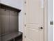 Mudroom with custom shelving and bench beside an entry door, providing storage and convenience at 3927 Enclave Way, Tucker, GA 30084