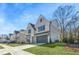 Side view of a modern two-story home with light brick, showcasing its architectural details and well-maintained lawn at 3927 Enclave Way, Tucker, GA 30084