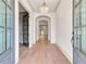 Bright foyer with hardwood floors, arched doorways, and a modern chandelier creating a grand entrance at 3927 Enclave Way, Tucker, GA 30084