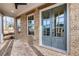 Close-up of the elegant brick entryway featuring a stylish glass-paneled door and exposed beam accents at 3927 Enclave Way, Tucker, GA 30084