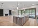 Open concept kitchen with large island, stainless steel appliances, and adjacent living room with fireplace at 3927 Enclave Way, Tucker, GA 30084