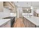 Modern kitchen with stainless steel stove, white countertops, and custom cabinetry at 3927 Enclave Way, Tucker, GA 30084