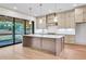 Bright, modern kitchen with large island, stainless steel appliances, and sliding glass doors to the outside at 3927 Enclave Way, Tucker, GA 30084